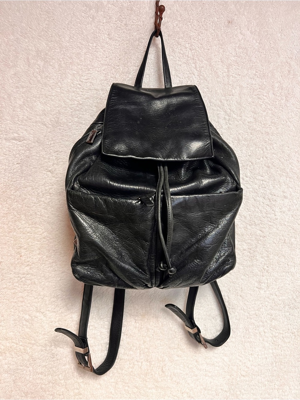 Perlina Black Leather Drawstring Flap Backpack